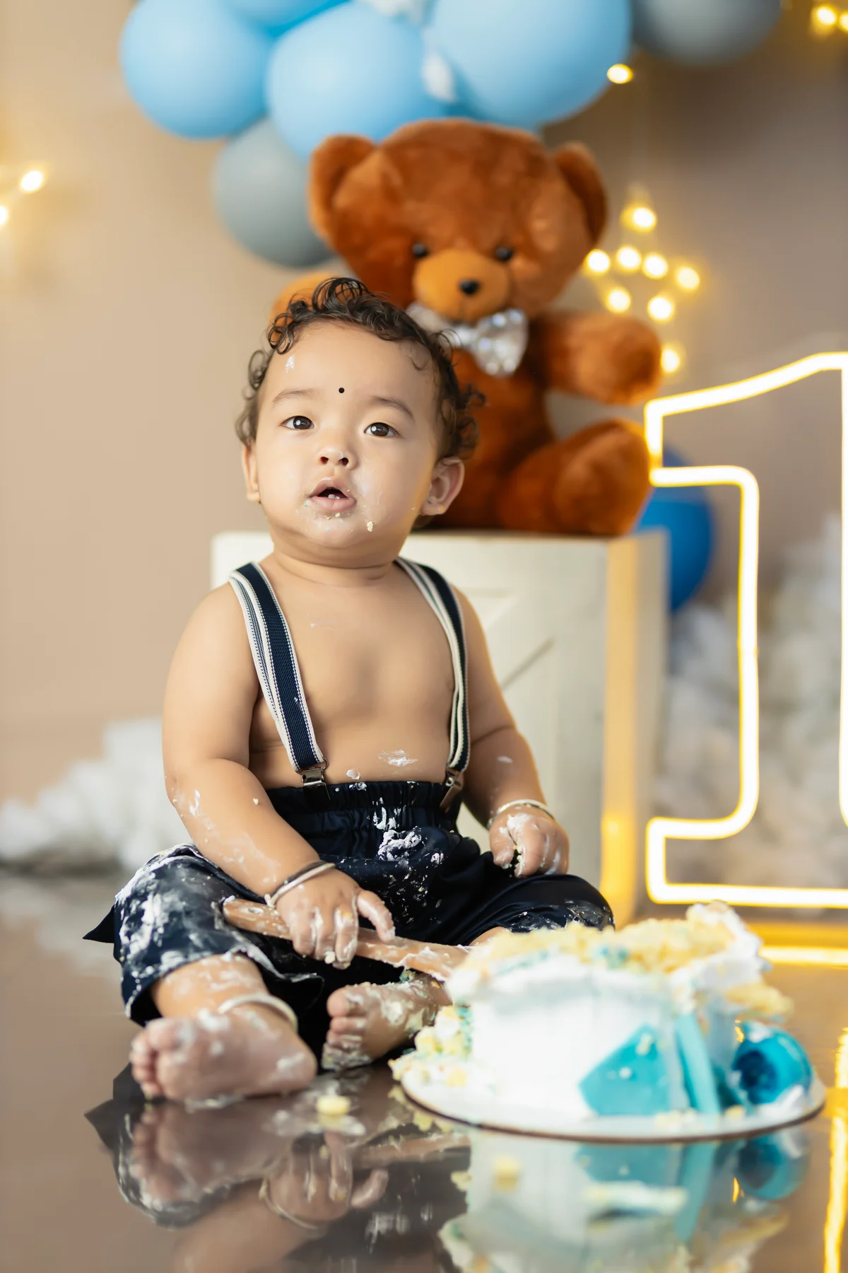 Cake smash photography — baby's first birthday celebration with frosting at Cute Galleries, Kathmandu